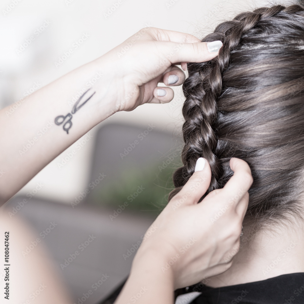 Naklejka premium Creating a braided hairstyle