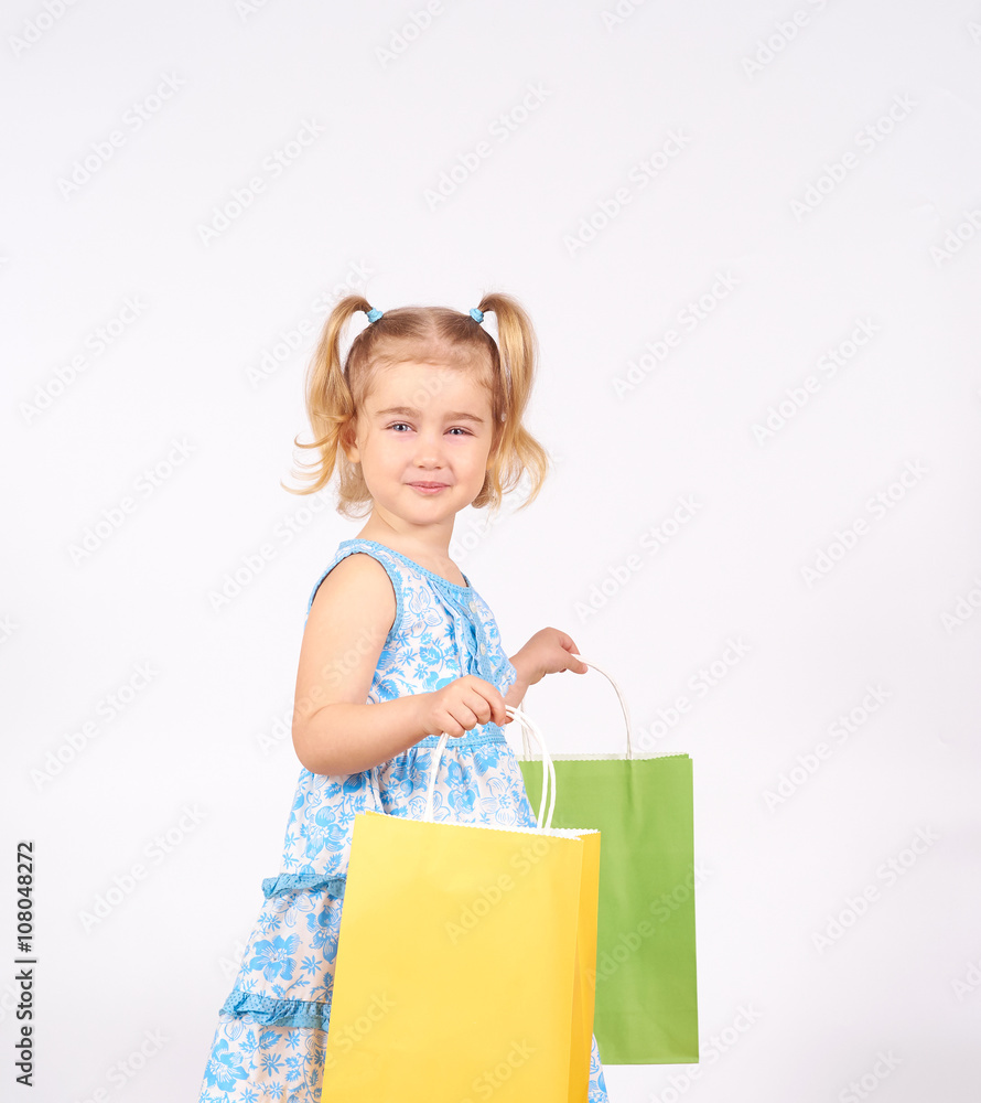 Shopping child. little girl holding shopping bags Shopping child. little girl holding shopping bags