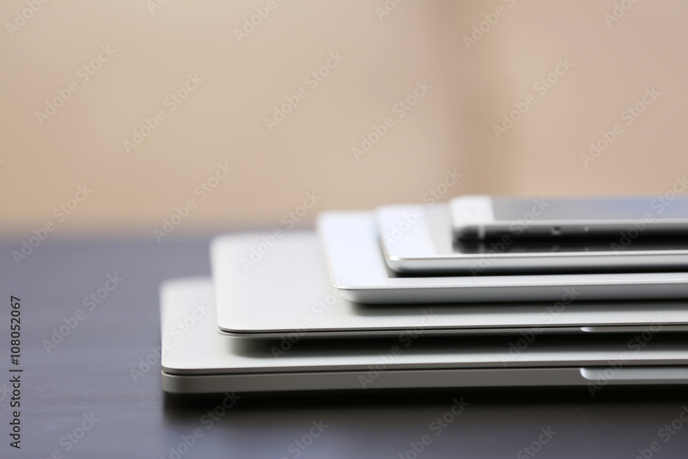 Stack of electronic devices on a dark desk