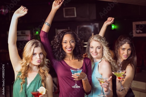 Portrait of friends having a drink in a bar 