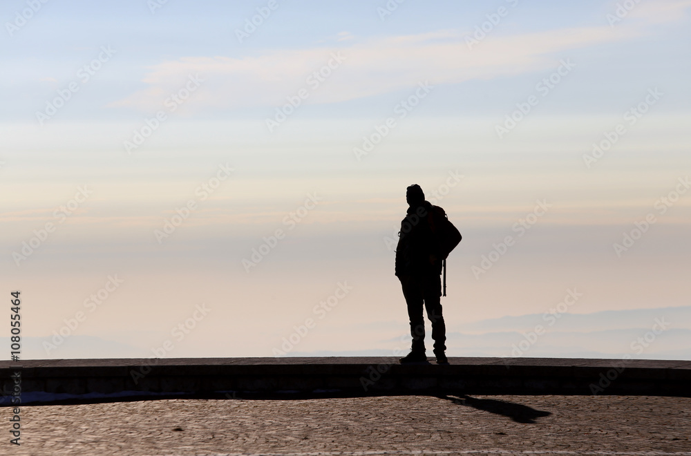man admires the view from the top of a mountain
