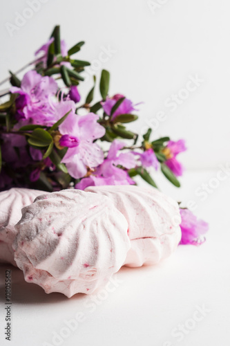 Pink zephyr on the white wooden background. Shallow depth of field.