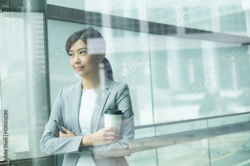 Free Download Businesswoman holding with coffee cup inside office building - GFXLoad