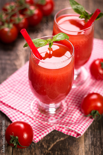 Tomato Juice and Fresh Tomatoes on a Wooden Background