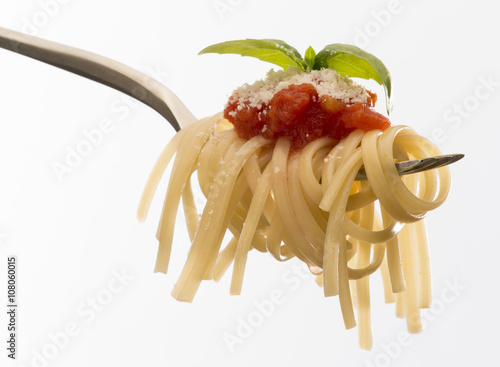 fork with spaghetti and tomato sauce isolated on white background
