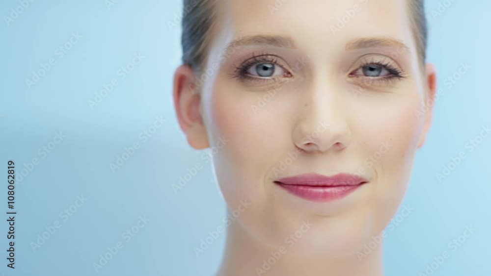 Woman blinks into camera while camera is moving from right to left Woman blinks into camera while camera is moving from right to left