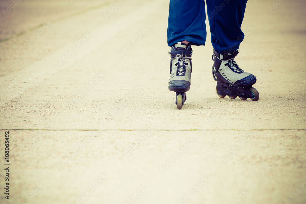 Human legs rollerblading wearing sportswear.