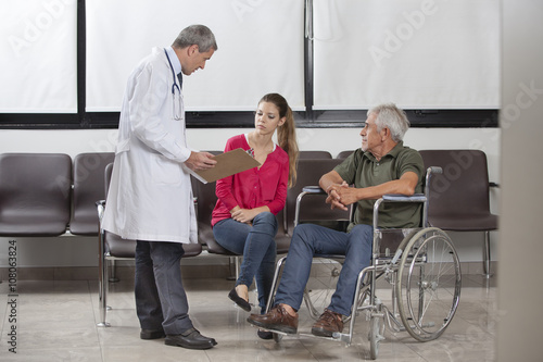 Doctor consulting with a patient and his family
