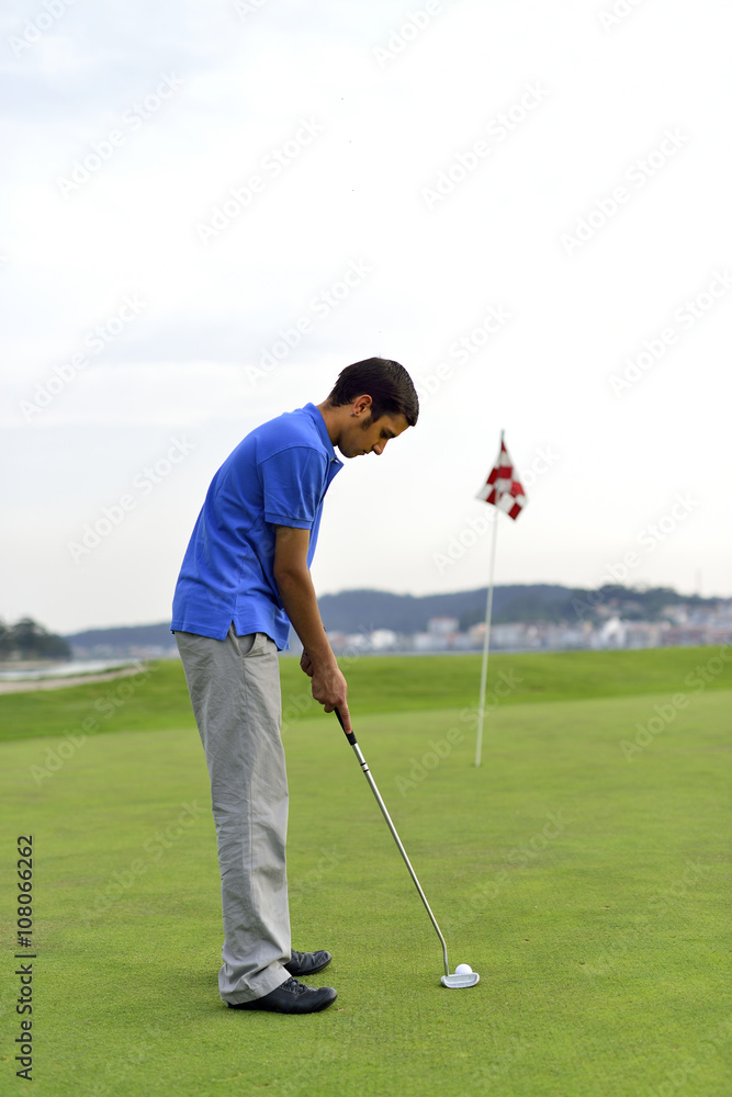 Fototapeta premium Young man playing golf