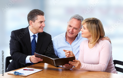 Senior couple with insurance agent.