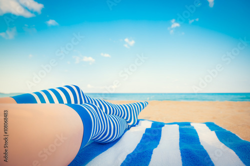 Slim woman legs on a beach