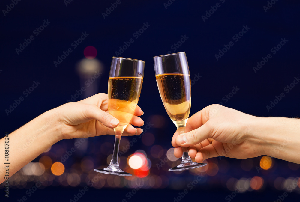 Man and woman hands with full champagne glasses