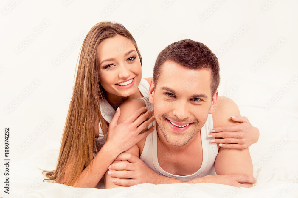 Pretty young girl huging her boyfriend in bed Pretty young girl huging her boyfriend in bed