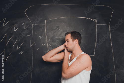 Young man against the background of chalkboard sleeping and snor photo