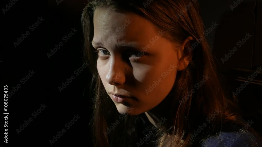 Young teen girl in the dark, UHD 4K Stock Video