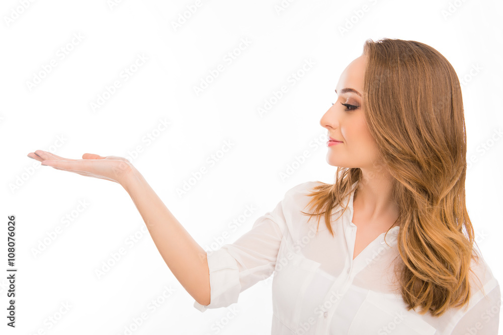 Portrait of pretty cute young woman showing product Portrait of pretty cute young woman showing product