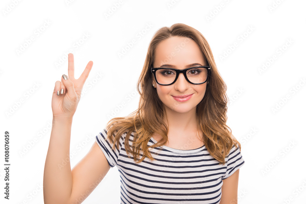Portrait of smiling young woman gesturing with two fingers Portrait of smiling young woman gesturing with two fingers