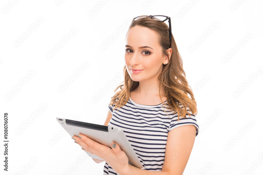 Smiling young girl with glasses holding tablet and chatting Smiling young girl with glasses holding tablet and chatting