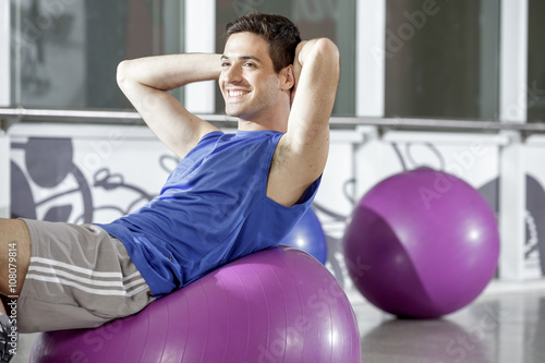 man working out with a fitness ball
