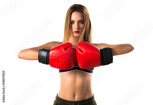 Teen girl with boxing gloves © luismolinero
