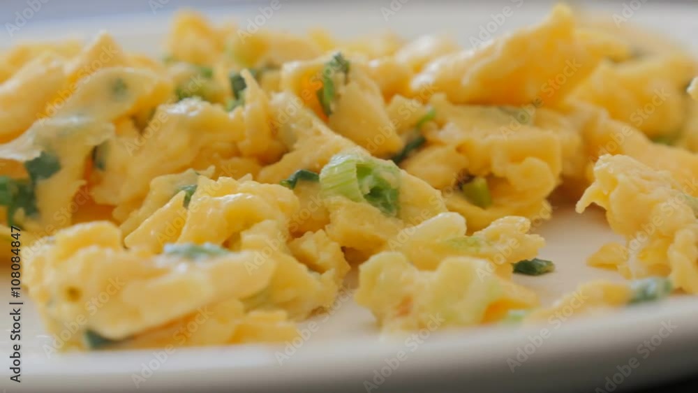 Beaten eggs and scallion breakfast on plate close-up pan 4K 2160p 30fps UHD video - Panning on plate with eggs scrambled fried as omelette 4K 3840X2160 UltraHD footage Beaten eggs and scallion breakfast on plate close-up pan 4K 2160p 30fps UHD video - Panning on plate with eggs scrambled fried as omelette 4K 3840X2160 UltraHD footage