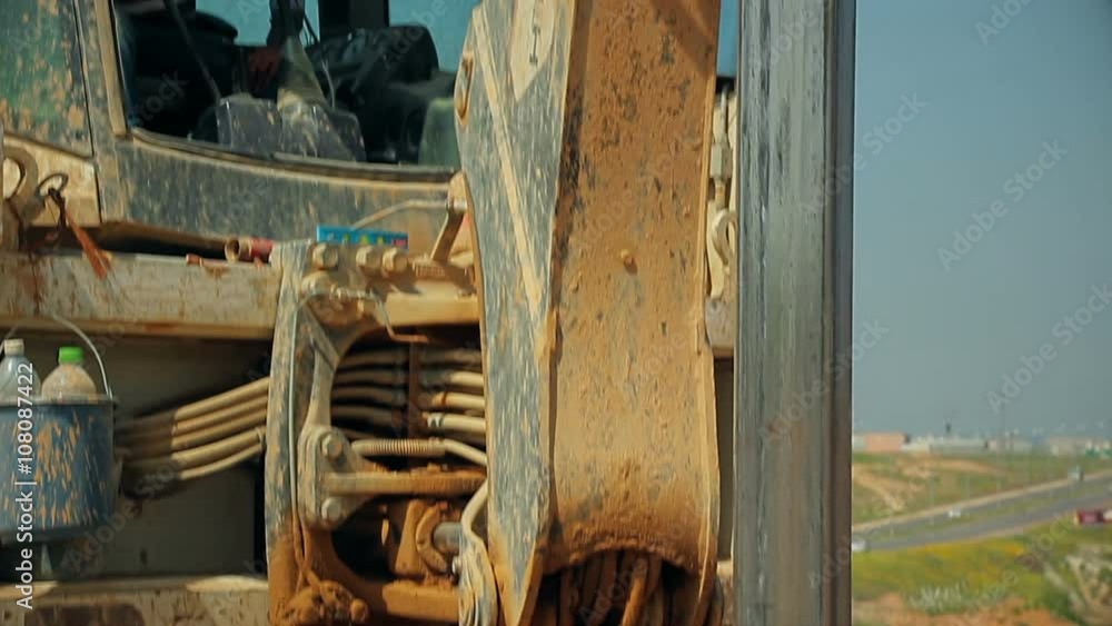 Tractor with a drilling device at a construction site. Tractor with a drilling device at a construction site.