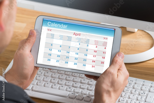 Businessman Using Calendar On Digital Tablet