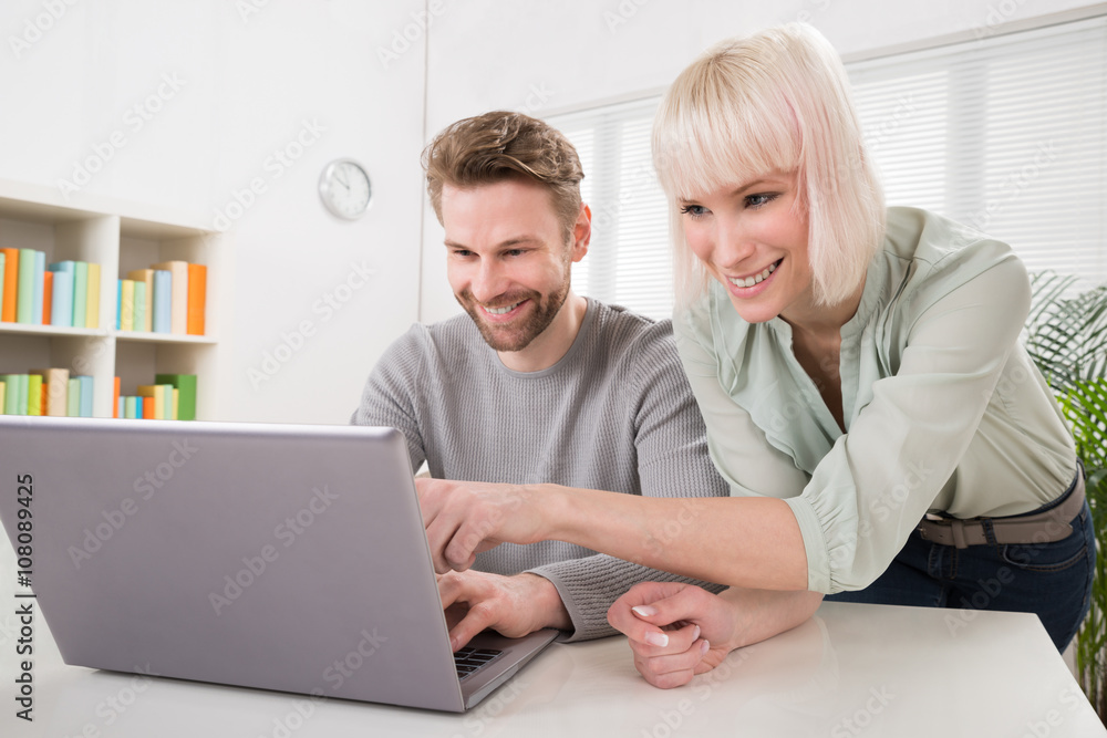 Young Couple Using Laptop Young Couple Using Laptop