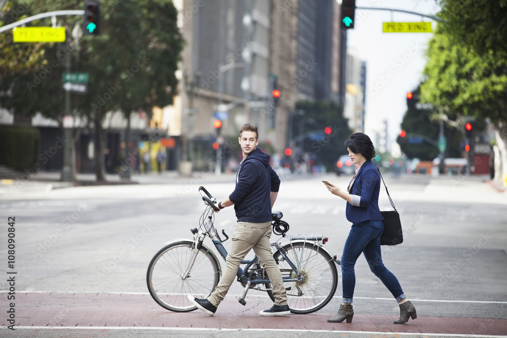 Caucasian business people crossing city street Caucasian business people crossing city street