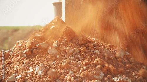 Tractor with a drilling device at a construction site.
