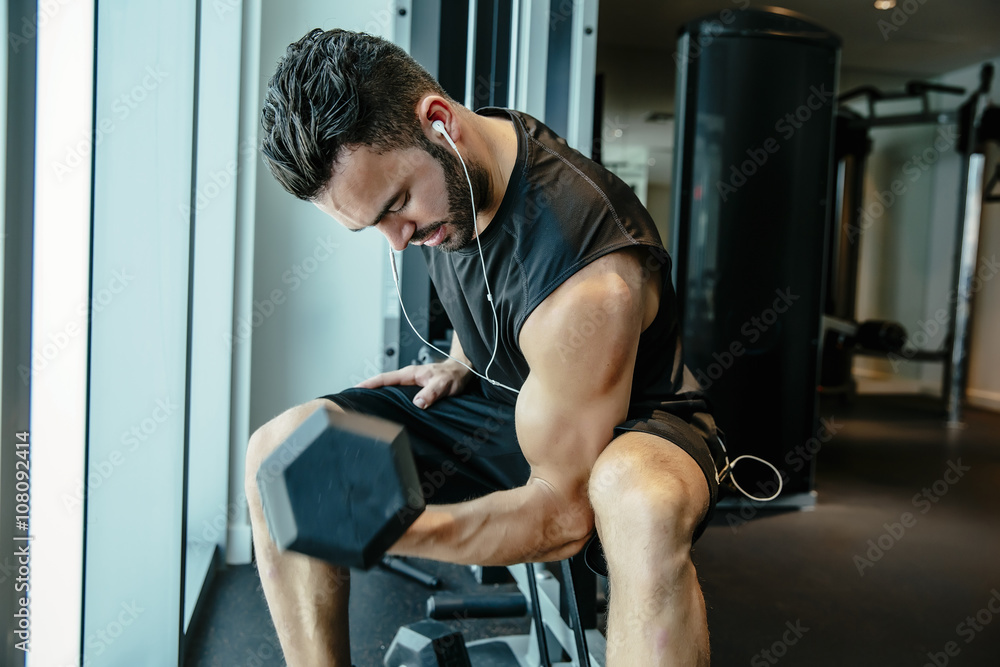 Man lifting weights in gymnasium Man lifting weights in gymnasium