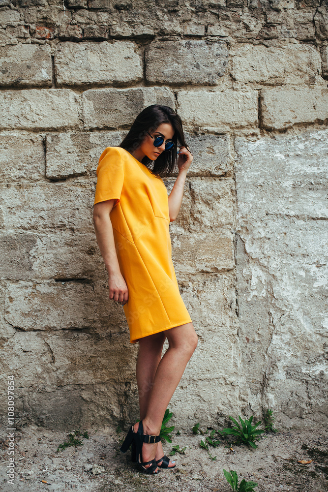 Attractive fashion woman in yellow dress