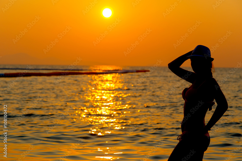 Portrait of young woman as silhouette by the sea