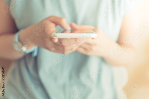 Young woman holding smarthphone in hand