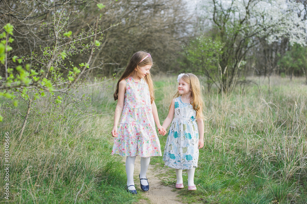Sisters playing and running Sisters playing and running