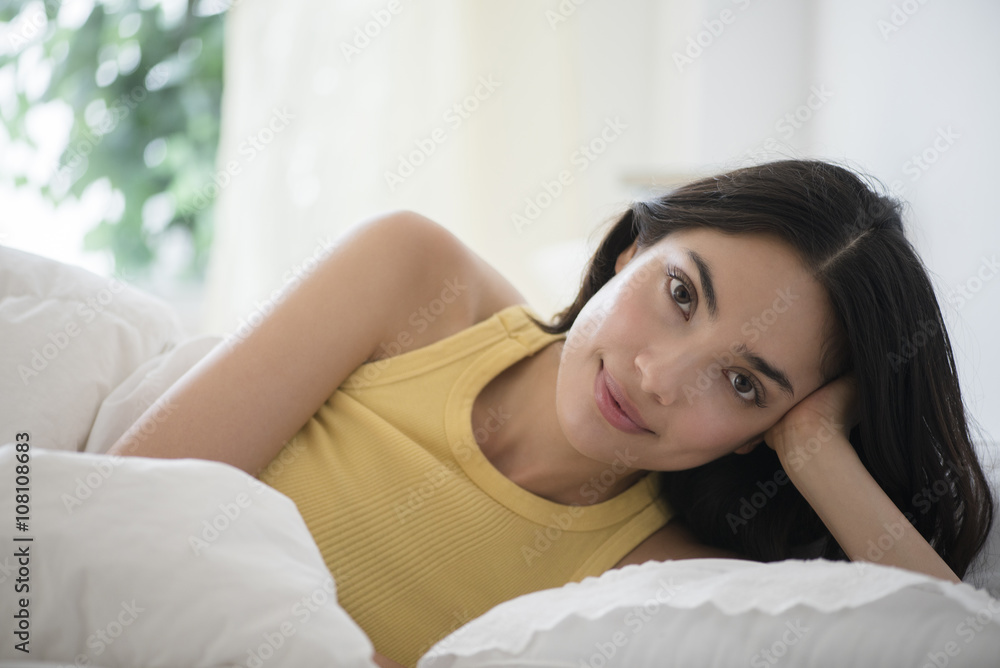 Hispanic woman laying in bed Hispanic woman laying in bed