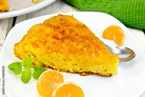 Pie mandarin with mint and spoon on board