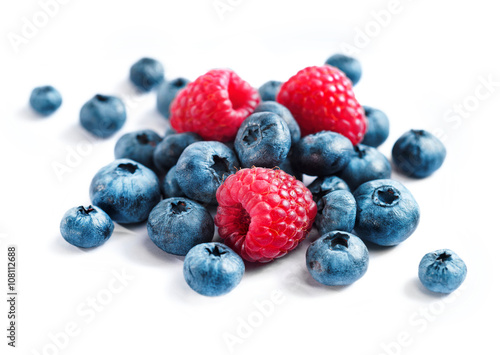 Berries blueberries and raspberries on white background. Close up, top view, high resolution product. Harvest Concept