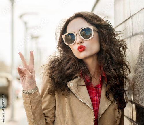 Pretty woman blowing lips kiss. Outdoors. Young smiling woman. S © Svetlana Fedoseeva