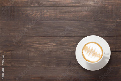 Coffee cup on wooden background. Top view
