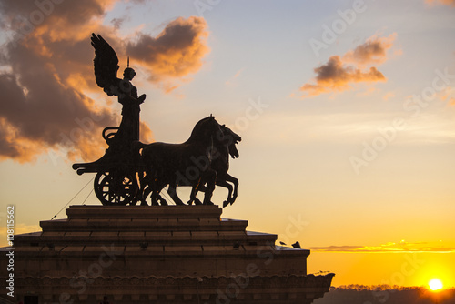 Goddess Victoria riding on quadriga, Altar of the Fatherland on the sunset. Rome, Italy