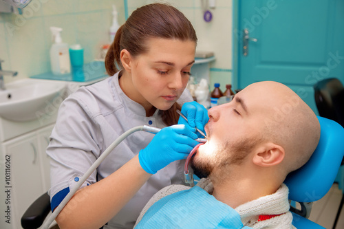 beautiful Man having teeth examined at dentists
