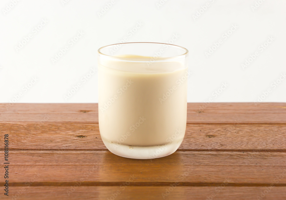 A grass of milk on wooden table A grass of milk on wooden table