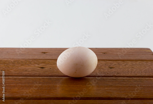 Duck egg on wooden table 