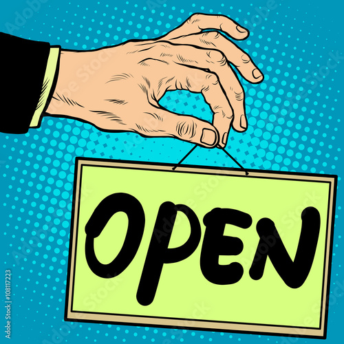 Hand holding a sign open