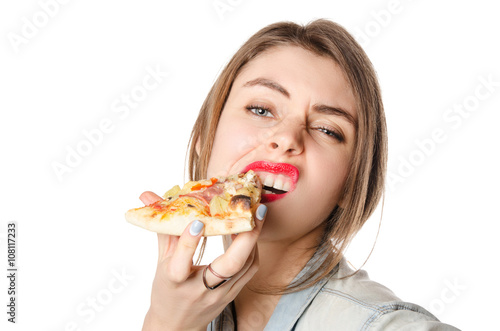 Pretty young sexy woman eating big slice of pizza standing on white background