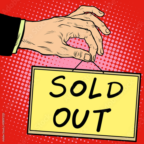 Hand holding a sign sold out