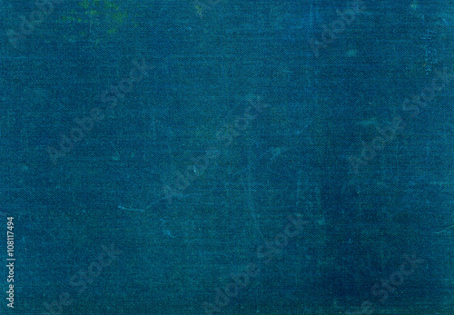 Grungy dark green textile surface with scratches.