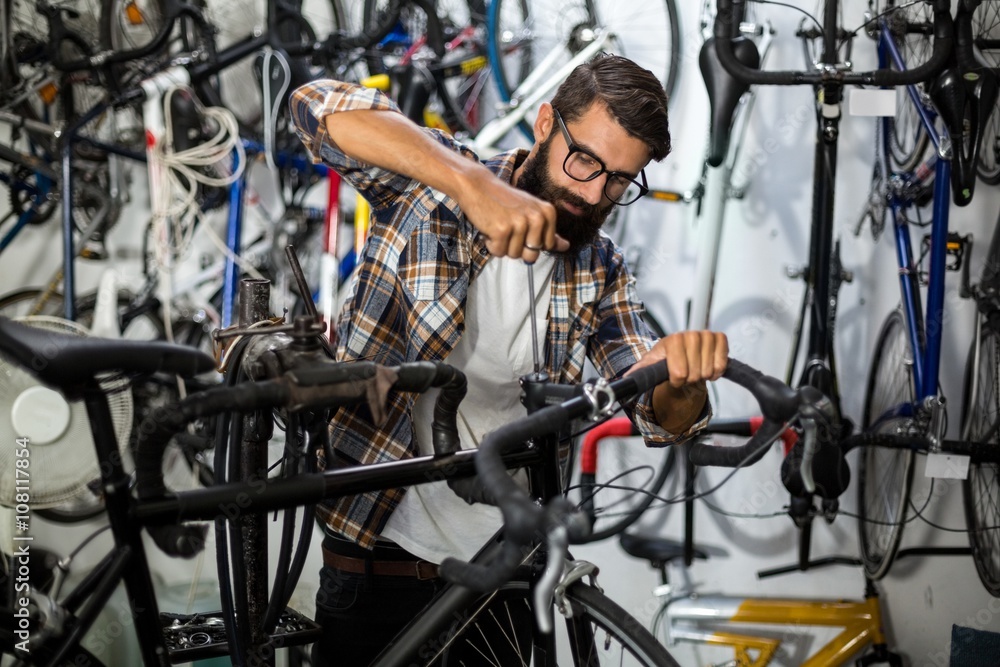 Bike mechanic checking at bicycle Bike mechanic checking at bicycle