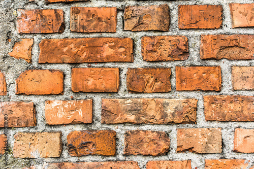 Old brick wall background, aged orange brick texture